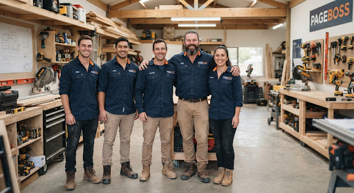 Authentic contractor crew portrait standing in workshop wearing work uniforms and smiling
